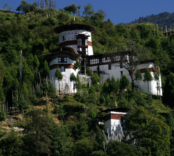 Trongsa Ta Dzong watchtower set among green forested hills in central Bhutan