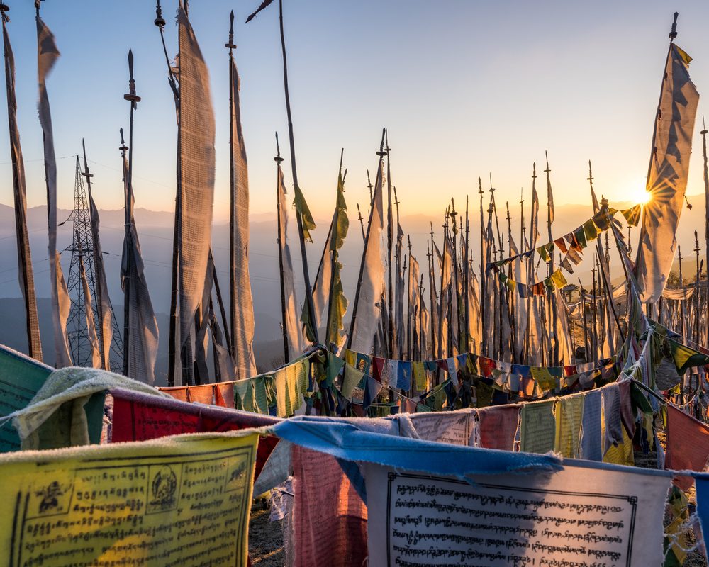 Buddhist prayer flags at sunrise in the mountains of Bhutan